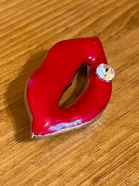 Red lips brooch on silver tone backing with large cubic zirconia 1 3/4 w x 3/4 l